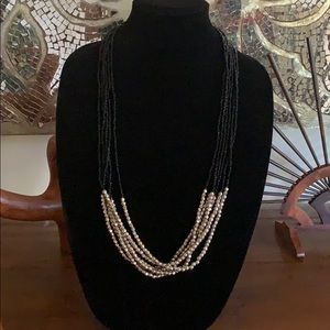 Long beaded black and silver tone necklace
